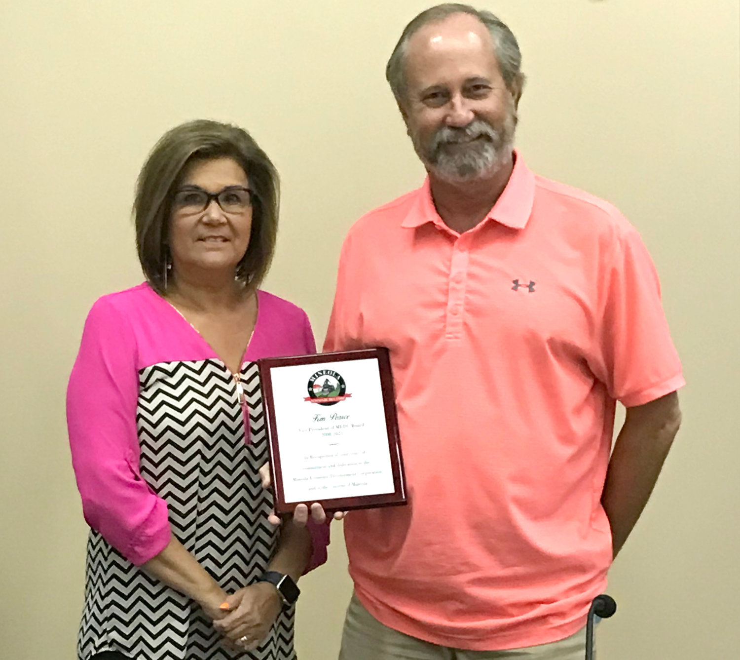 Mineola City Manager Mercy Rushing congratulates Ken Pearce for his service to the Mineola Economic Development Corp. board of directors.